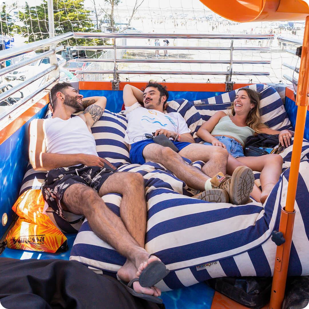 Three young people laying on bed outside
